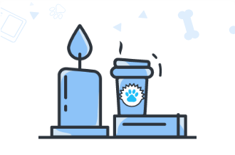 A candle burning next to a cup of coffee